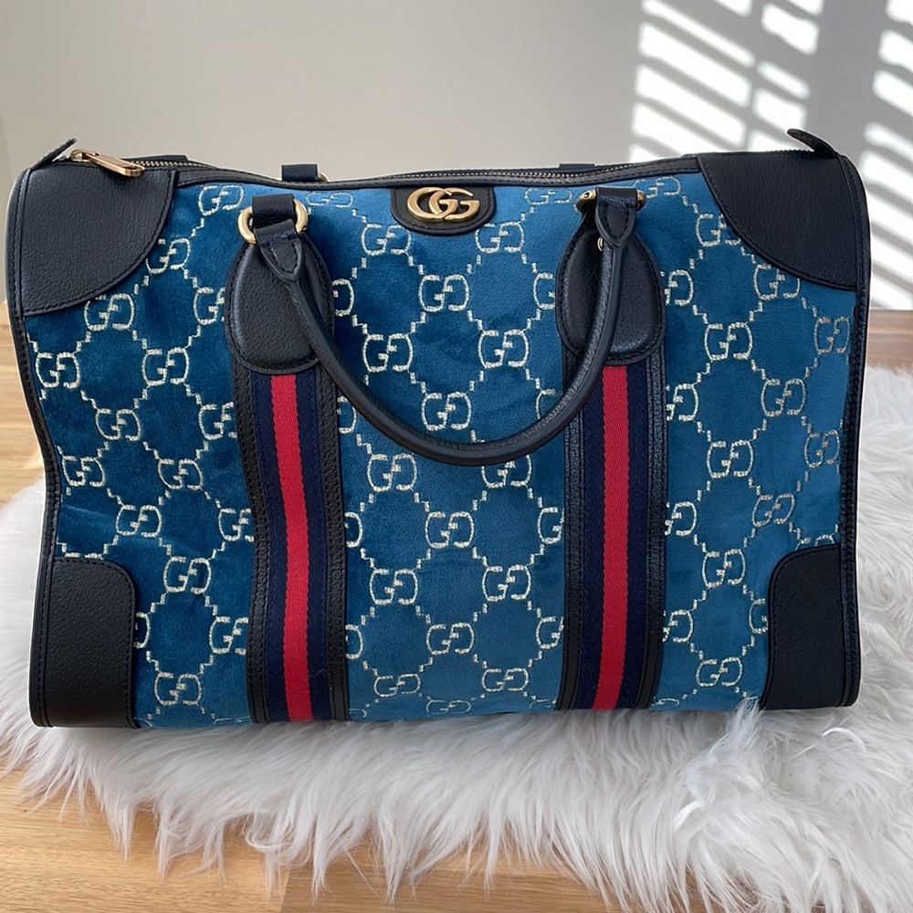 Gucci blue velvet monogram duffle bag with shoulder strap.